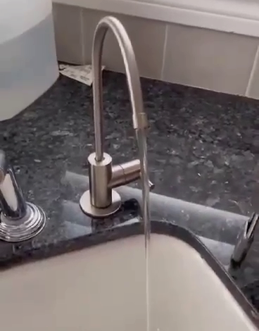 Dedicated reverse osmosis drinking faucet mounted beside the main kitchen tap